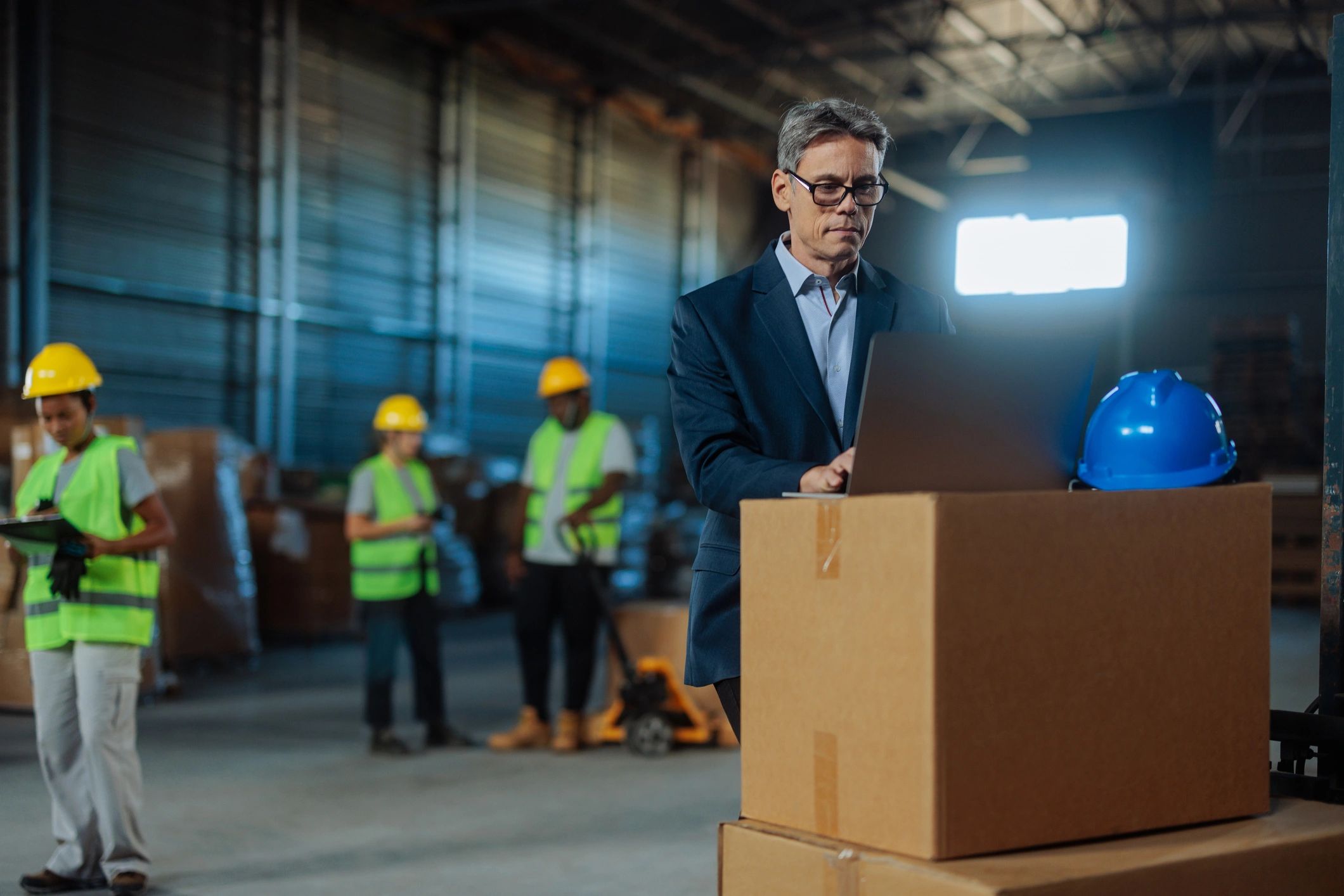 Warehouse manager using a laptop for fulfillment operations