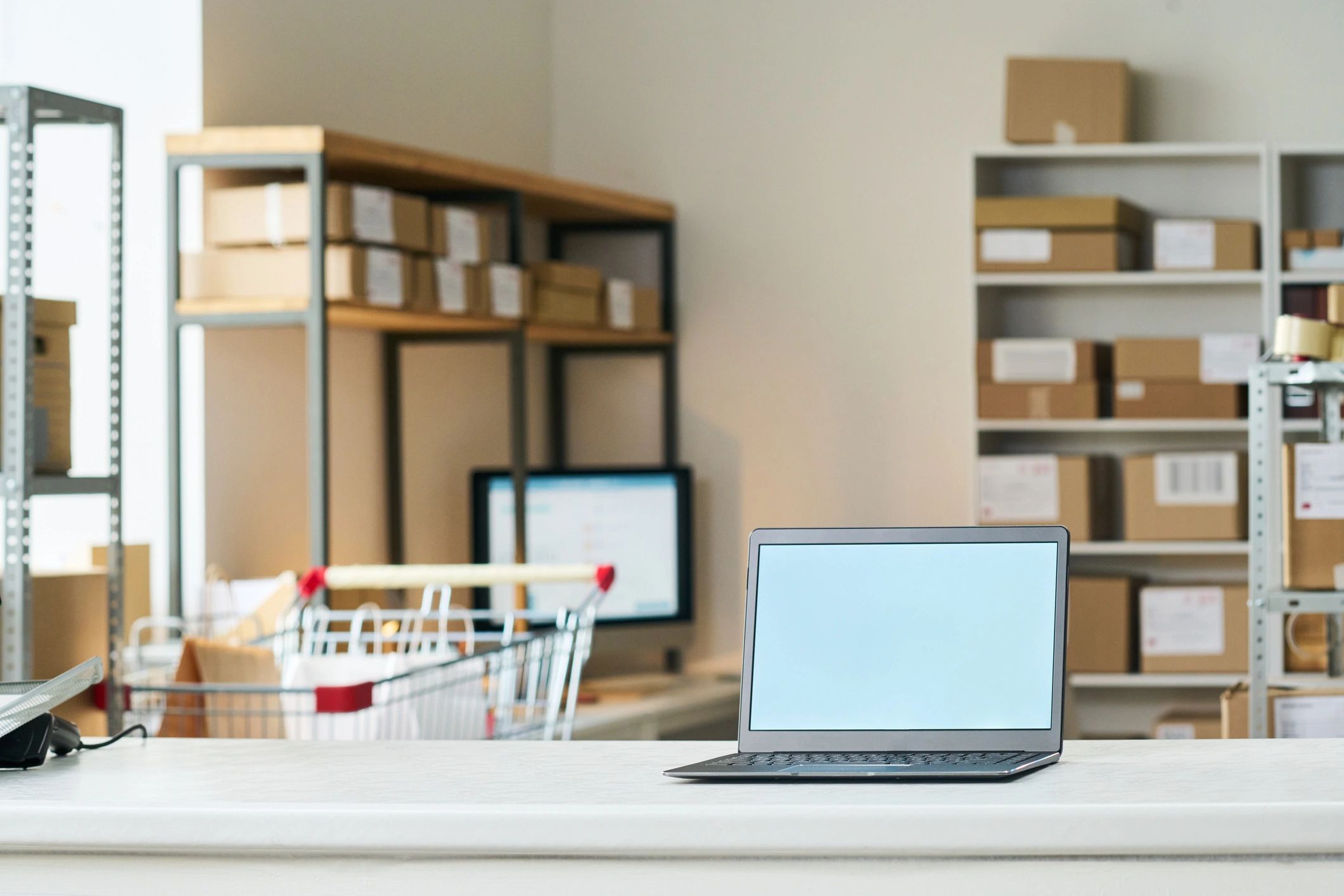 E-commerce operations workspace with laptop and packaged orders