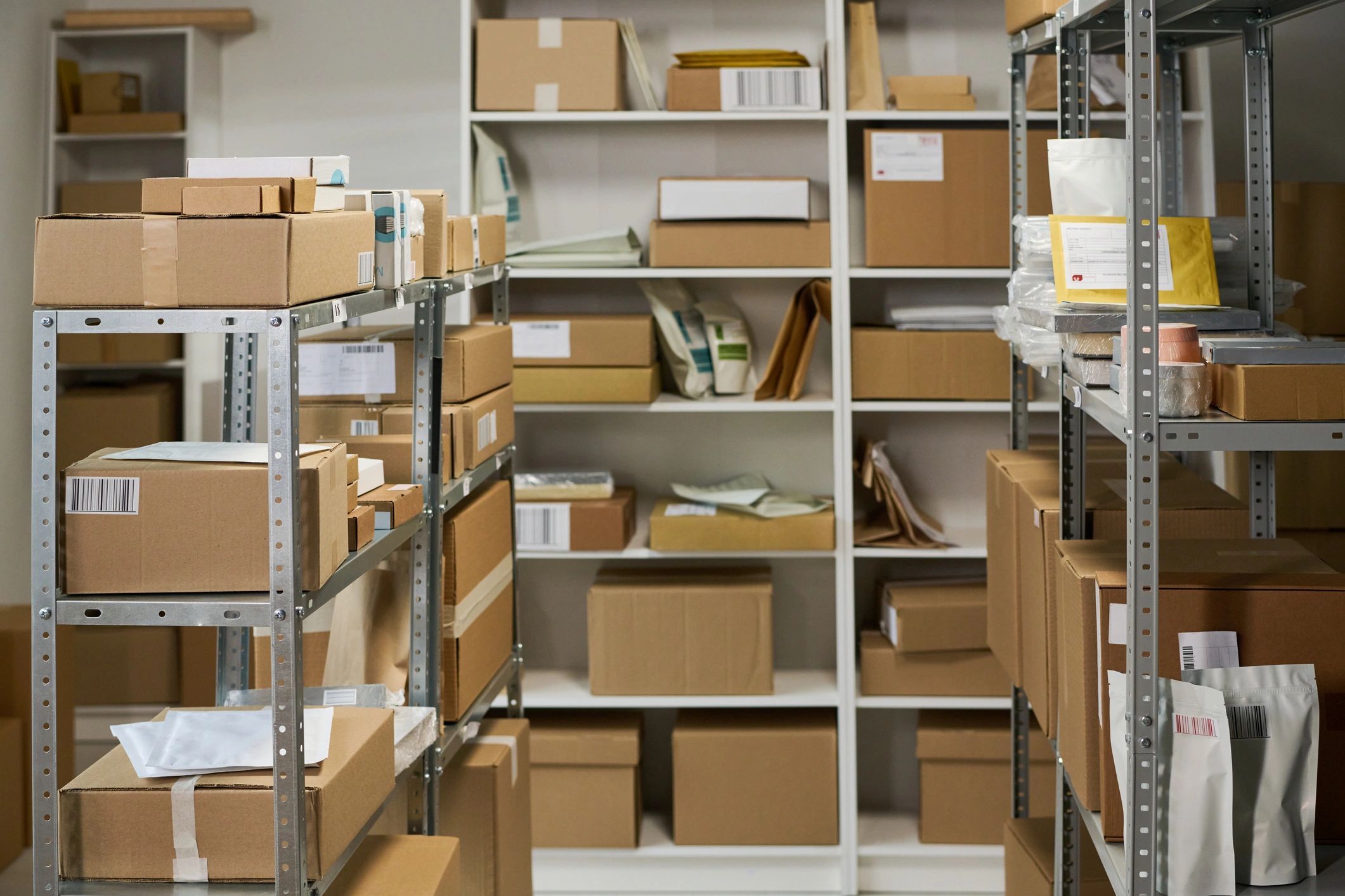 Warehouse shelves with packed parcels for e-commerce fulfillment